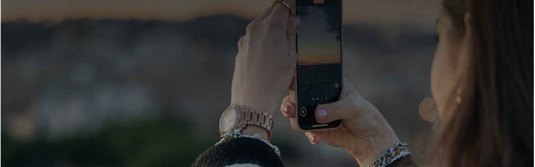 Una donna fa una foto con lo smartphone al panorama 