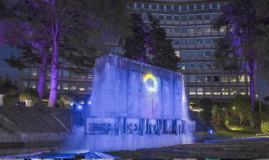 Il logo Acea proiettato, di notte, sulla fontana illuminata