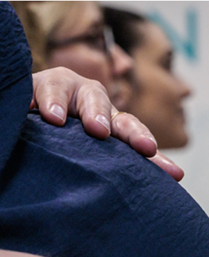 Detail of a pregnant woman's hand resting on her belly