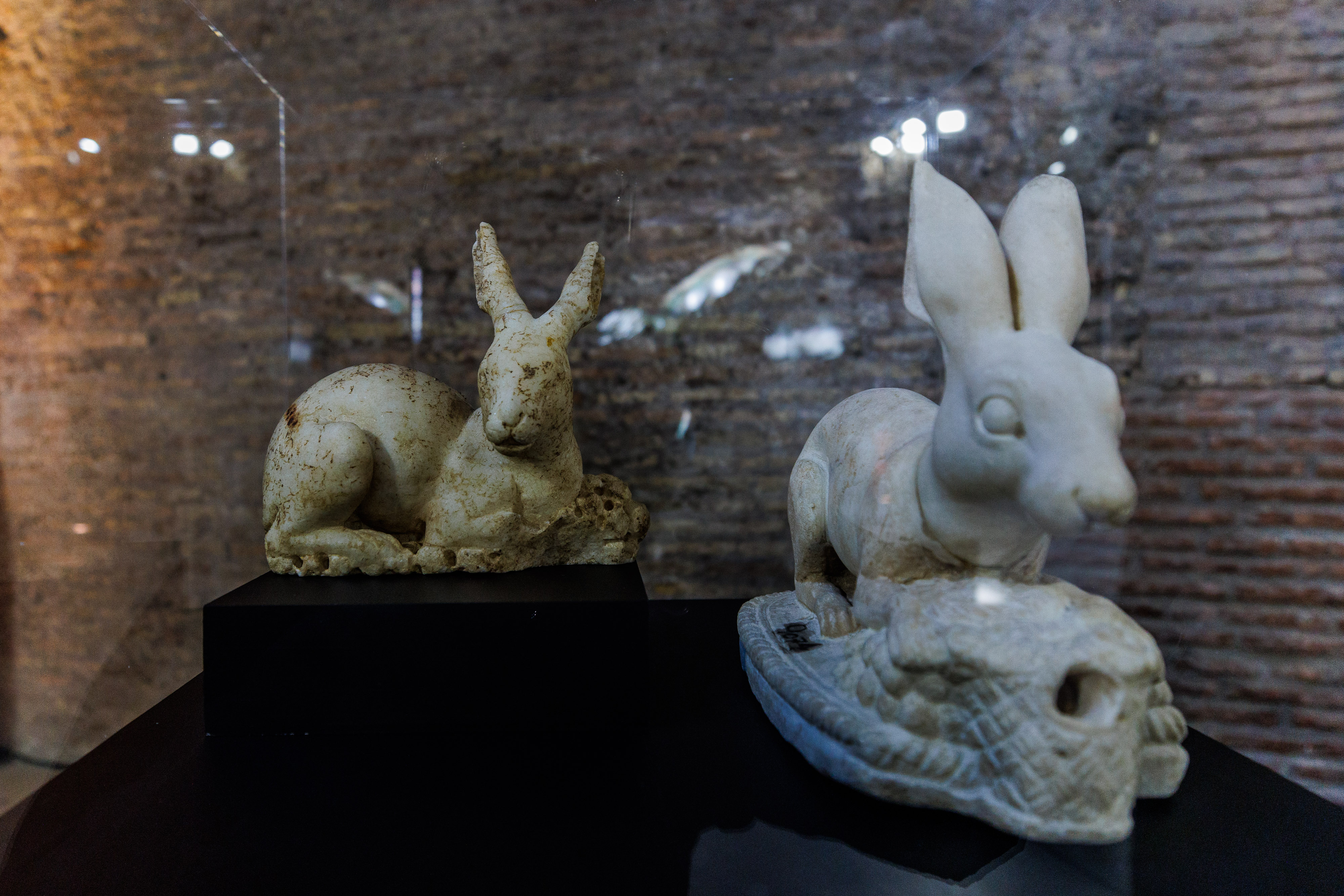 two rabbit-shaped archaeological artefacts, preserved in national and municipal museums.