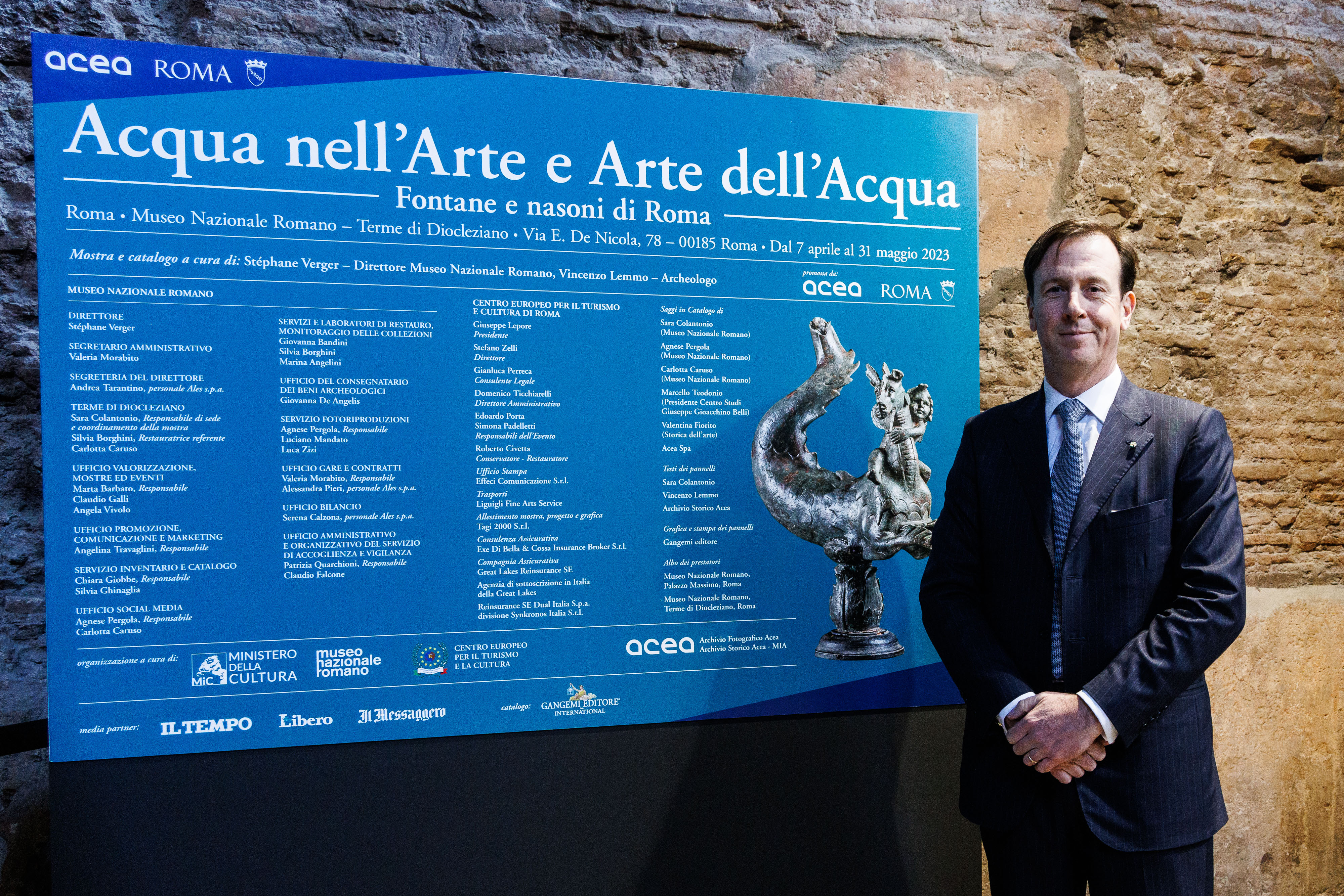 Fabrizio Palermo, CEO of Acea next to the exhibition panel bearing the title ‘water in art and art in water