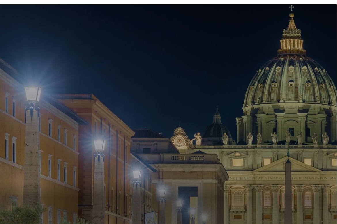 Illuminated Via della Conciliazione chandeliers, with St Peter's Basilica behind them