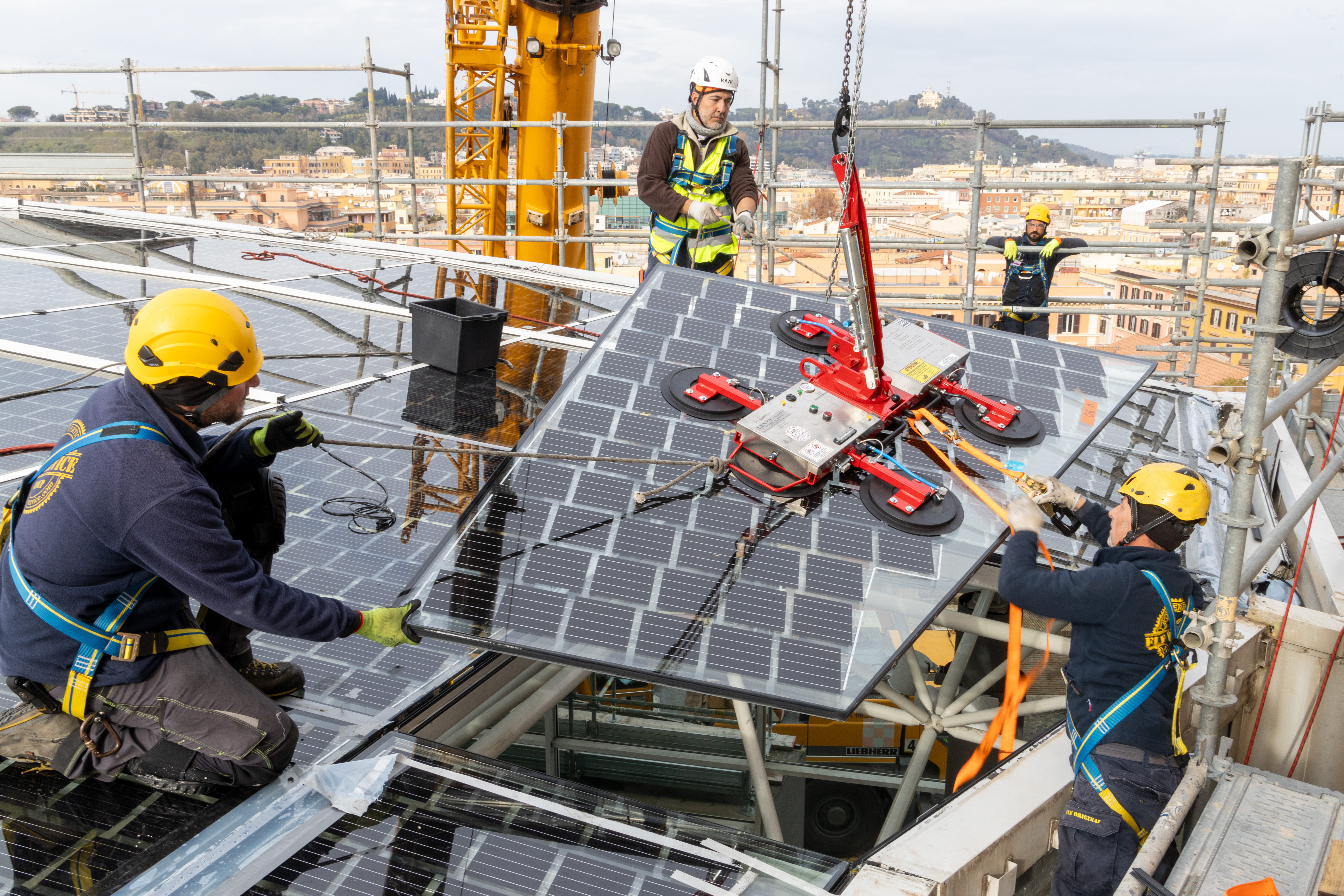 3 workers with protective equipment while installing a photovoltaic panel